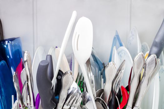 Gathering of dishes in the silverware rack. 