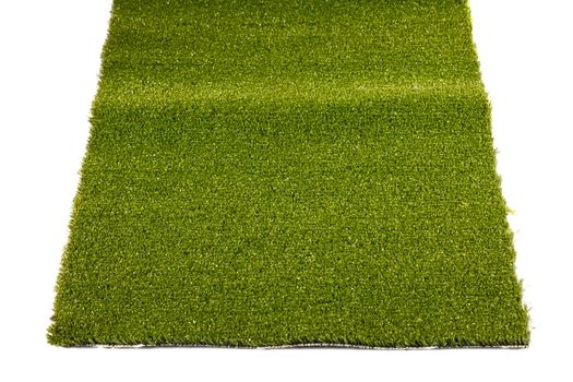 a piece of green artificial grass on a white background