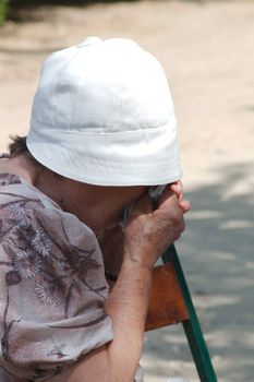 An elderly woman grieves