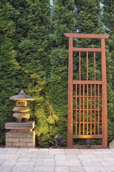 Japanese Stone Pagoda Lantern and Trellis in Backyard Paver Patio