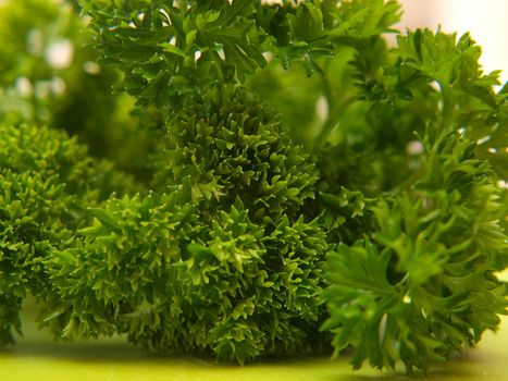 Closeup of fresh green parsley, on green chop board