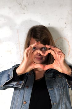 woman showing a heart symbol
