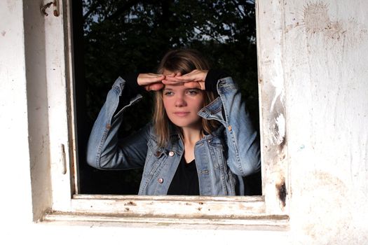 woman looking through window