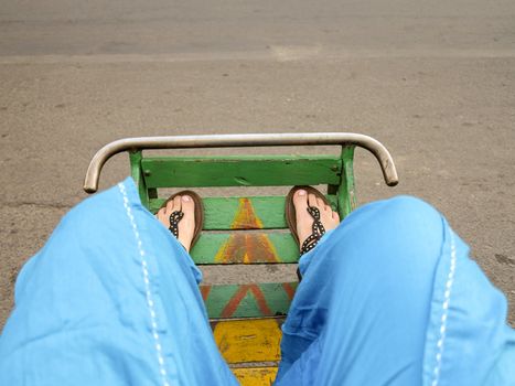 Feet of customer or tourist in the footbed of cyclo in Phnom Penh Cambodia