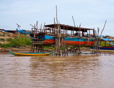 Floating village on Lake Tonle Sap in Cambodia with some houses made from boats