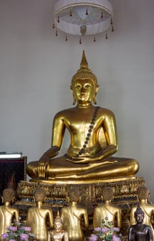 Ornate golden buddha statue in Wat Po temple near Bangkok in Thailand