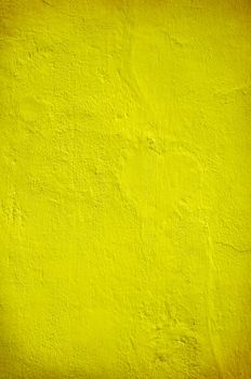 Plastered yellow green wall in closeup