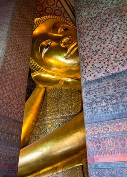 Detail of head and arm of reclining Buddha in Wat Po Temple in Thailand