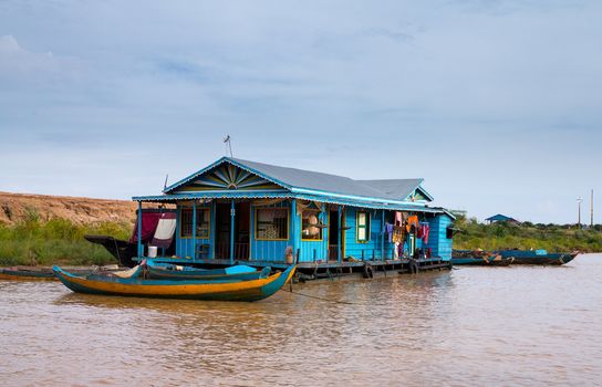 Floating village on Lake Tonle Sap in Cambodia with some houses made from boats