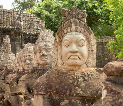 South gate to angkor thom in Cambodia is lined with warriors and demons