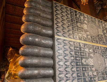 Detail of feet and toes of reclining Buddha in Wat Po Temple in Thailand