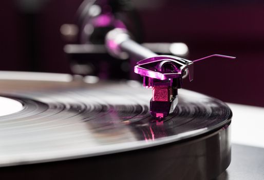 Long Playing record LP on retro record player with tone arm and cartridge