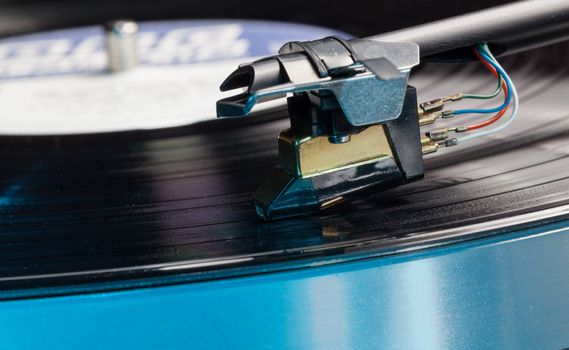 Long Playing record LP on retro record player with tone arm and cartridge
