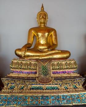Ornate golden buddha statue in Wat Po temple near Bangkok in Thailand
