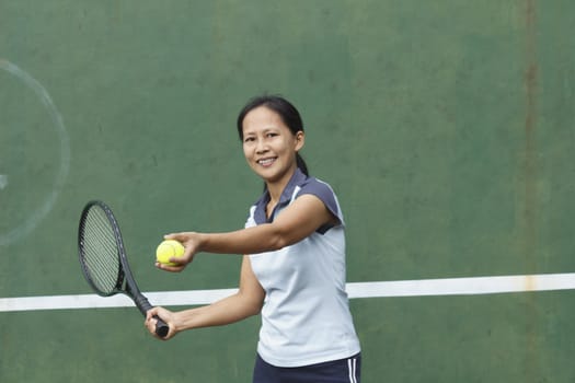 Female tennis player getting ready to hit forehand stroke