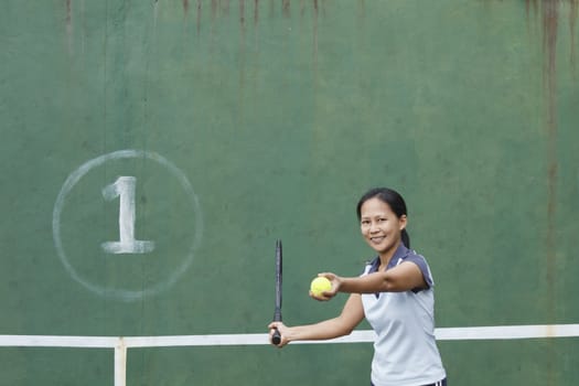 Female tennis player getting ready to hit forehand stroke