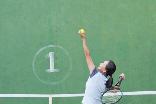 Female tennis player getting ready to serve