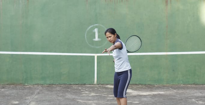 Female tennis player getting ready to hit forehand stroke