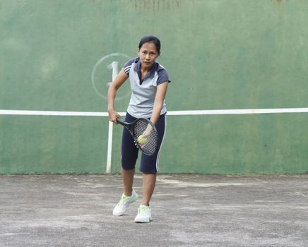 Female tennis player getting ready to serve