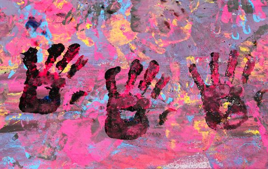 Baby hand paint with black on a full mixed color board