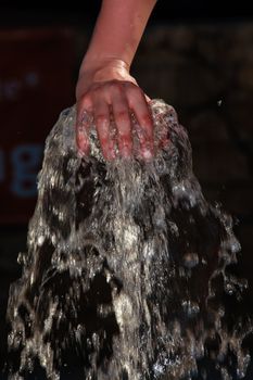 female hand on a water fountain