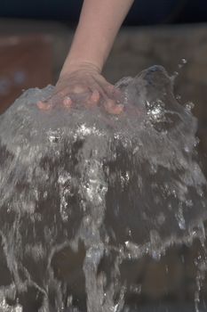 female hand on a water fountain