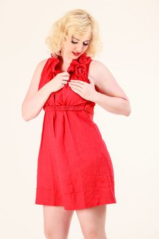 Blonde woman in a red dress with romantic expression