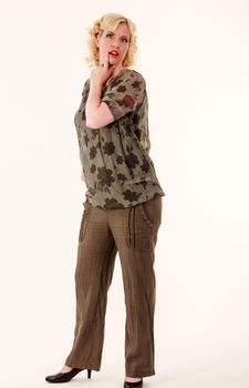 Blonde lady with big clothes with linen trousers and transparent blouse