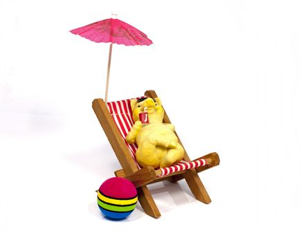yellow bear in a beach chair drinking with a straw