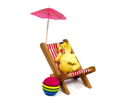 yellow bear in a beach chair drinking with a straw