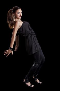 Beautiful fashionable woman posing on black background 