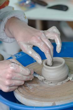 The potter engaged in manufacturing clay of products