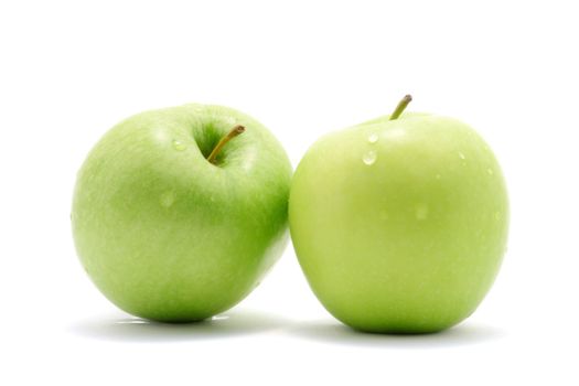 Two green apples over white background