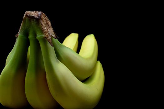 Bunch of bananas over black background