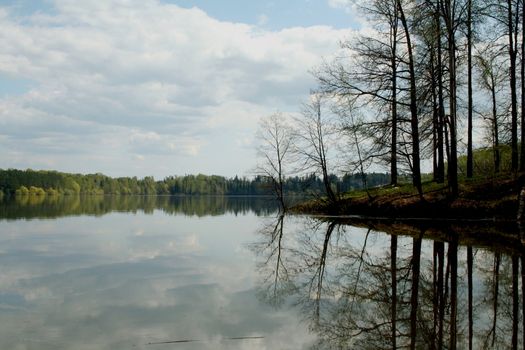 Landscape with lake, forest, and blue sky