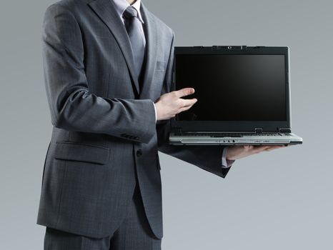 Businessman holding his laptop