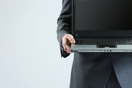 Businessman holding his laptop