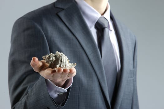 businessman with shell in hand