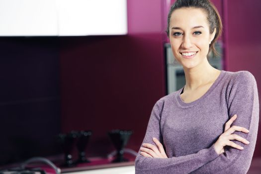 portrait of beautiful young woman in kitchen