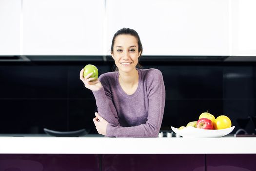 portrait of beautiful young woman in kitchen