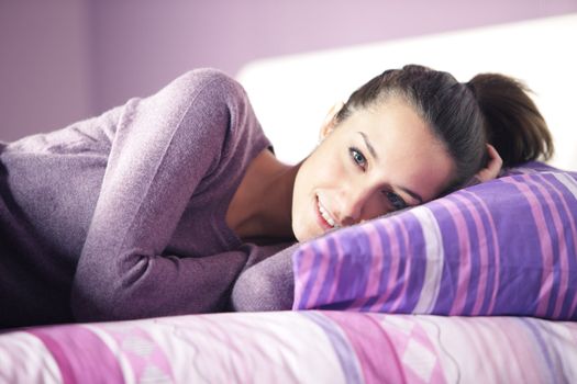 Closeup of a young woman lying on bed