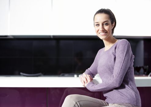 portrait of beautiful young woman in kitchen