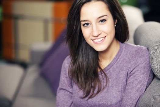 Portrait of a beautiful young woman on couch