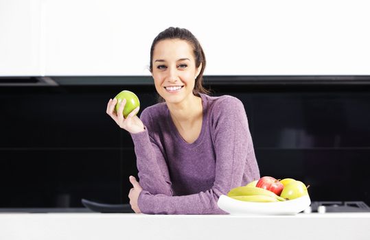 portrait of beautiful young woman in kitchen