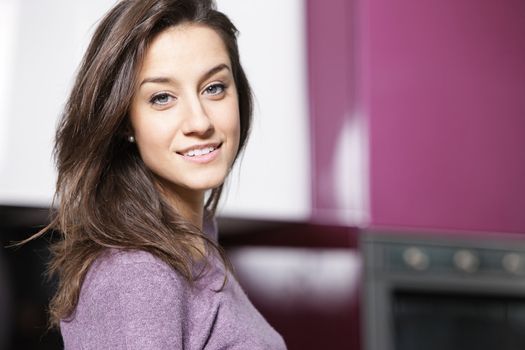 portrait of beautiful young woman in kitchen