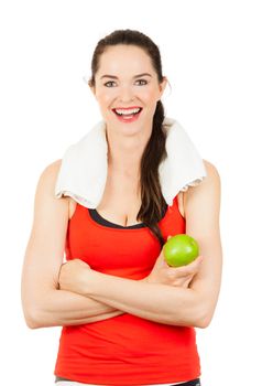 Young happy fit woman holding an apple and smiling after exercise. Isolated on white.