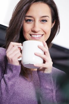 Portrait of a cute young lady with a cup of coffee