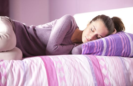 Close-up of an attractive young female sleeping in bed at home