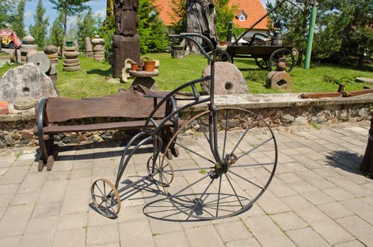 Retro vintage rusty bicycle imitation made of steel in park.