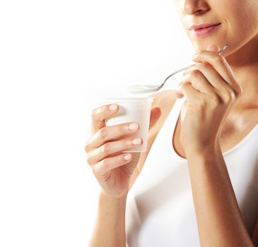 Young woman eating yogurt , close up